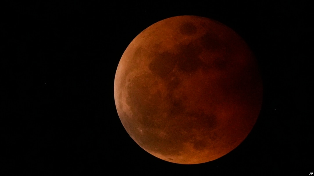 FILE - The moon rises during a lunar eclipse in metro Manila, Philippines, Nov. 8, 2022. A similar event, visible from the Western Hemisphere, will happen March 13, 2025.