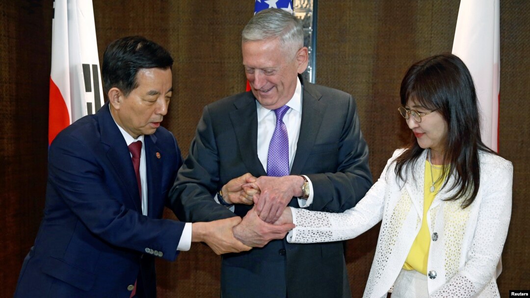 South Korea's Defense Minister Han Min-koo shows U.S. Secretary of Defense Jim Mattis and Japan's Defense Minister Tomomi Inada how to do a handshake during a trilateral meeting on the sidelines of the 16th IISS Shangri-La Dialogue in Singapore, June 3,