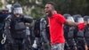 A protester yells at police in front of the Baton Rouge Police Department headquarters after police arrived in riot gear to clear protesters from the street in Baton Rouge, Louisiana, July 9, 2016. 