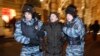 FILE - Police officers detain a protester during an unsanctioned protest in Moscow, Russia, Dec. 30, 2014.