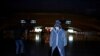 A man wearing a face mask and a plastic raincoat is seen at a railway station of Wuhan, China, March 28, 2020.