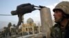 A U.S. soldier watches as a statue of Iraq's President Saddam Hussein falls in central Baghdad in this photo dated April 9, 2003.
