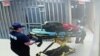 In this July 13, 2015, frame taken from video provided by the Waller County Sheriff's Department from a motion-operated camera, emergency personnel carry a gurney near Sandra Bland's jail cell, at the Waller County jail in Hempstead, Texas.