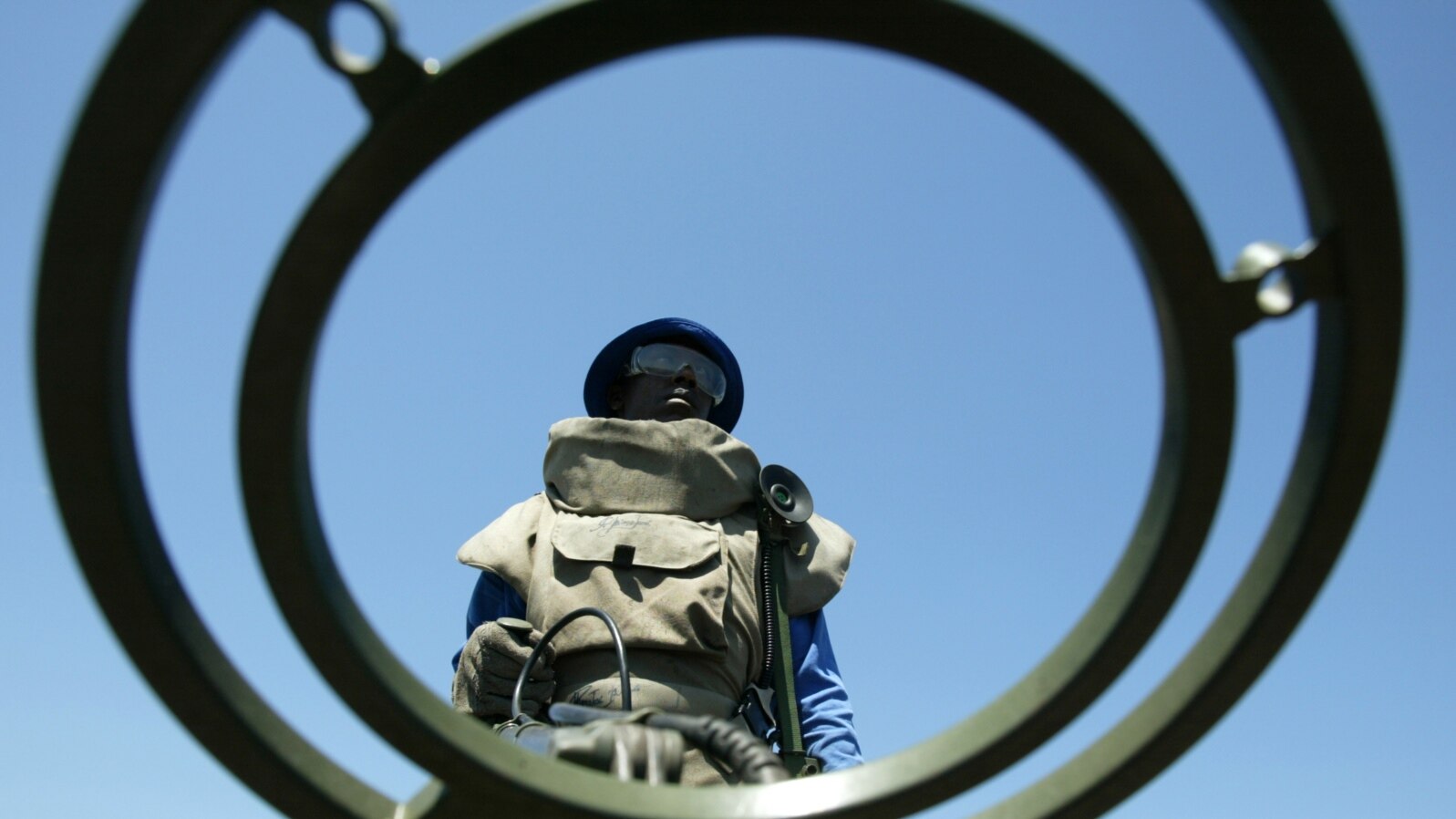 FILE - An anti-personnel mine detecting worker stands at a mine field near Vilancoulos in southern Mozambique, 450 km (265 miles) north east of Maputo, Nov. 2004 file photo. 