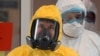 FILE - Russian President Vladimir Putin wears a protective suit as he visits a hospital for coronavirus patients in Kommunarka, outside Moscow, March 24, 2020.