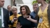 FILE - Speaker of the House Nancy Pelosi, D-Calif., is surrounded by reporters as she arrives to meet with her caucus at the Capitol in Washington, after declaring she will launch a formal impeachment inquiry against President Donald Trump.