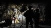 FILE - A U.S. Army officer, accompanied by an interpreter, talks to an Afghan resident while on a night patrol in Kandalay village, Afghanistan, Aug. 4, 2011.