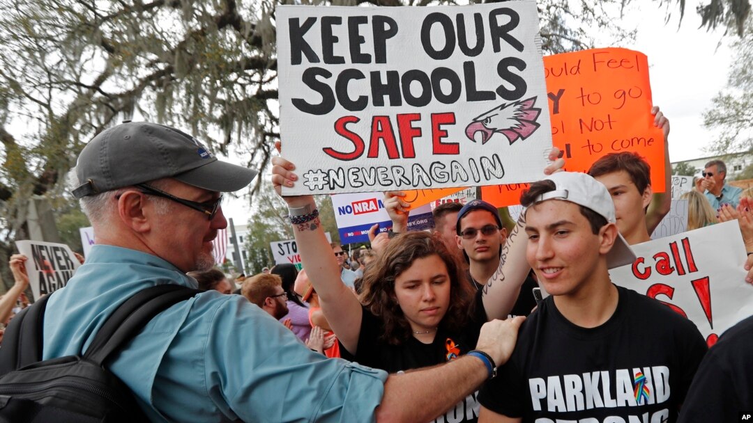 FILE - In this Wednesday, Feb. 21, 2018 file photo, student survivors from Marjory Stoneman Douglas High School are greeted as they arrive at a rally for gun control reform on the steps of the state capitol, in Tallahassee, Fla. (AP Photo/Gerald Herbert, File)