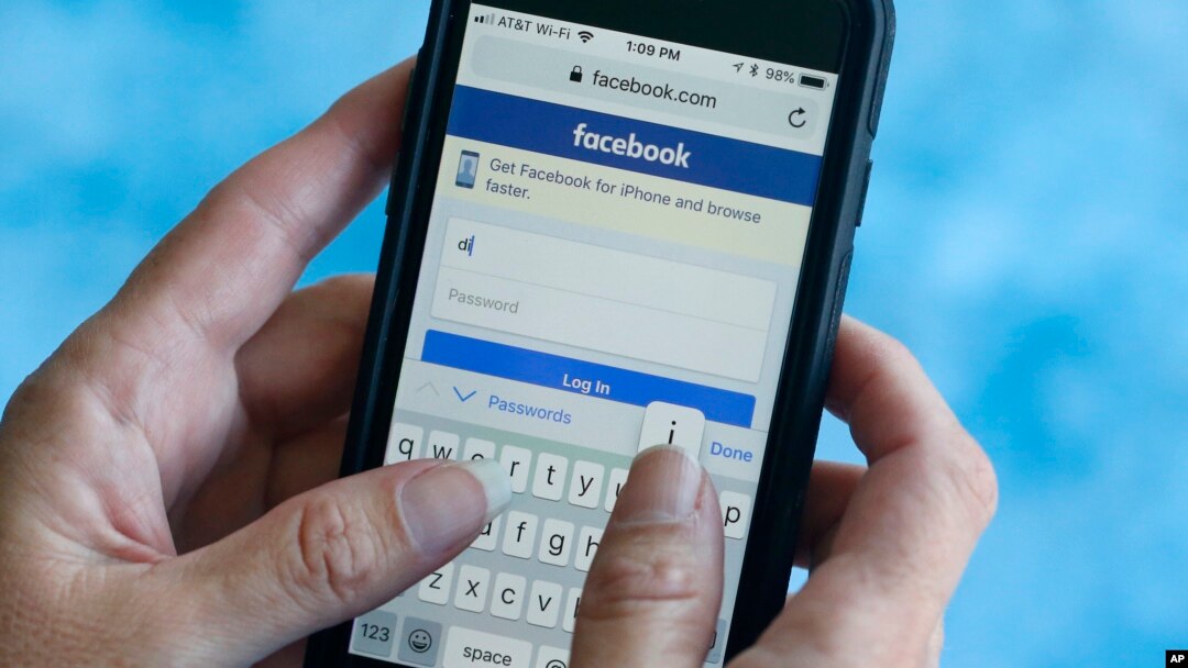 FILE - A Facebook start page is shown on a smartphone in Surfside, Florida. Aug. 21, 2018. The social media giant Facebook said late Wednesday Aug. 22, 2018, it has banned a quiz app for refusing to be audited and concerns that data on as many as 4 million users was misused, after it found user information was shared with researchers and companies.