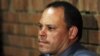 Investigating officer Hilton Botha, sits inside the court witness box during the Oscar Pistorius bail hearing at the magistrate court in Pretoria, South Africa, February 20, 2013.