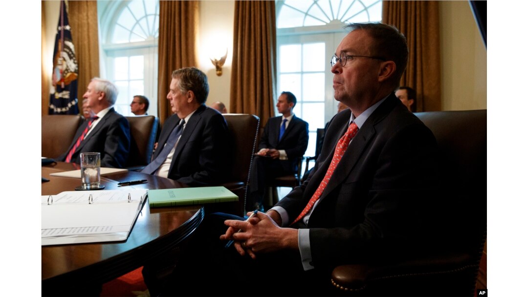 FILE - White House Chief of Staff Mick Mulvaney listens as President Donald Trump speaks during a cabinet meeting at the White House, Jan. 2, 2019, in Washington.
