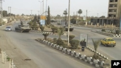 FILE - Syrian army tanks are seen in Deir al-Zour. 