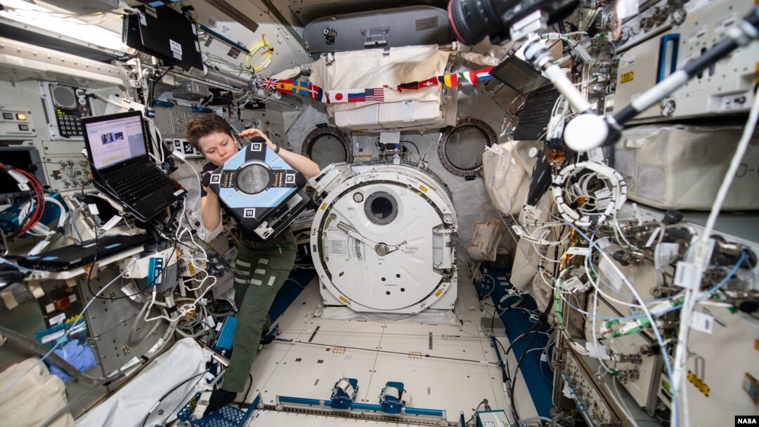 NASA astronaut Anne McClain checking out the new Astrobee hardware