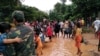 FILE - Villagers carry their belongings as they evacuate after the Xepian-Xe Nam Noy hydropower dam collapsed in Attapeu province, Laos, July 24, 2018.