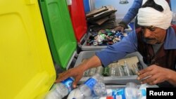 A worker sorts through recycling bins at a center that offers residents money in exchange of their recyclable garbage in an attempt to keep the streets clean in Cairo, Egypt, March 11, 2017. 