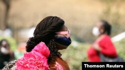 A woman wears a protective face mask following the closure of Wuse market for failing to adhere to COVID-19 prevention protocols in Abuja