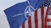 NATO and US flags wave in the wind outside NATO headquarters in Brussels. (File Photo) 