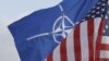 NATO and US flags wave in the wind outside NATO headquarters in Brussels. (File Photo) 