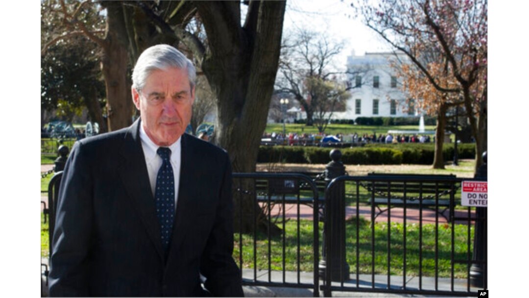FILE - Special Counsel Robert Mueller walks past the White House, March 24, 2019.