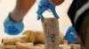 FILE - A Thai forensic expert collects a DNA sample from a confiscated elephant tusk, coming from Malawi, at Suvarnabhumi International Airport in Bangkok, Thailand, March 7, 2017.