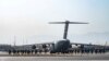 In this image provided by the Defense Department, two paratroopers assigned to the 1st Brigade Combat Team, 82nd Airborne Division, conduct security while a C-130 Hercules takes off during an evacuation operation in Kabul, Afghanistan, Aug. 25, 2021.