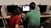 FILE - An Iranian man uses a computer at an Internet cafe, in Tehran, May 27, 2013. 