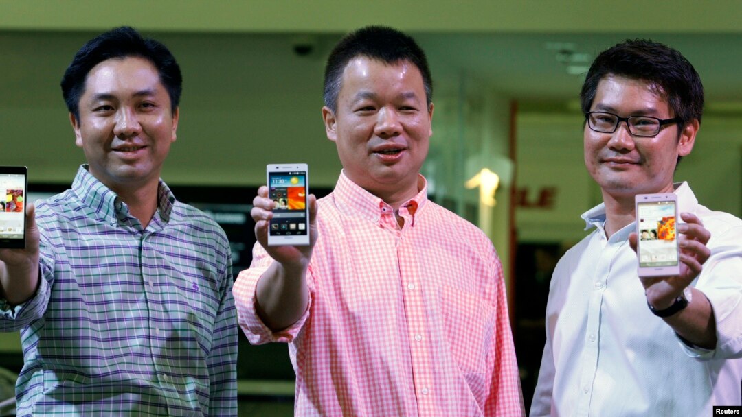 Huawei's Singapore CEO Zhou Bin (L-R), David Wei, President of Huawei South Pacific and Lim Chee Siong Chief Marketing Officer, Huawei South Pacific, show the new Huawei Ascend P6 Android-based smartphones during their launch at CommunicAsia communication