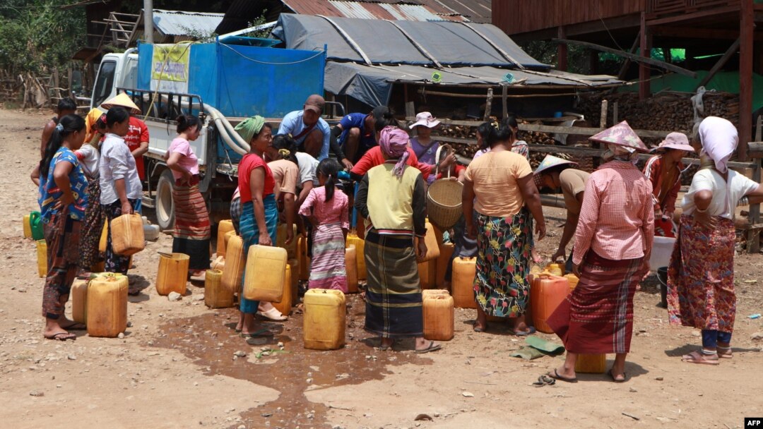 FILE - This photo taken on April 29, 2024, shows Kayah people gathering at a delivery of drinking water by the charity Clean Yangon at a camp for internally displaced people in Demoso township, in Myanmar's eastern Kayah state.