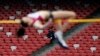 FILE - A security guard watches as a Russia athlete, front, makes an attempt at the women's high jump during the 2014 IAAF World Challenge Beijing held at China's National Stadium in Beijing, Wednesday, May 21, 2014. 