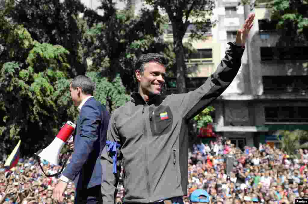 Venezuelan opposition leader Juan Guaido (L), who many nations have recognized as the country's rightful interim ruler, and fellow opposition leader Leopoldo Lopez address a crowd of supporters in Caracas. Lopez who had been put under house arrest by President Nicolas Maduro, was "freed" by soldiers supporting Guaido.