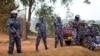 FILE - A line of riot police prevent the media and others from approaching Uganda's main opposition leader Kizza Besigye, who was placed under house arrest at his home in Kasangati, Uganda, Feb. 22, 2016. 
