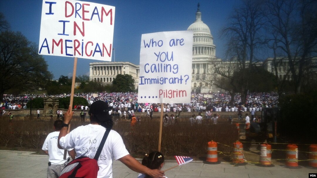 A father and daughter look out on the "All in for Citizenship" rally calling for an overhaul of U.S. immigration laws, Capitol HIll, Washington, DC, Wednesday, April 10, 2013. (Photo by Kate Woodsome)