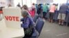 FILE - Voters fill in their ballots at a crowded polling station on North Carolina's first day of early voting for the general elections, in Carrboro, N.C., Oct. 20, 2016. 