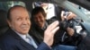 FILE - Algerian President Abdelaziz Bouteflika, left, and his brother Said Bouteflika arrive at campaign headquarters in the Hydra district of Algiers, April 10, 2009.