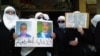 Women hold pictures of missing relatives as they protest against Syria's President Bashar al-Assad, in Daria, near Damascus, Jan. 19, 2012. 