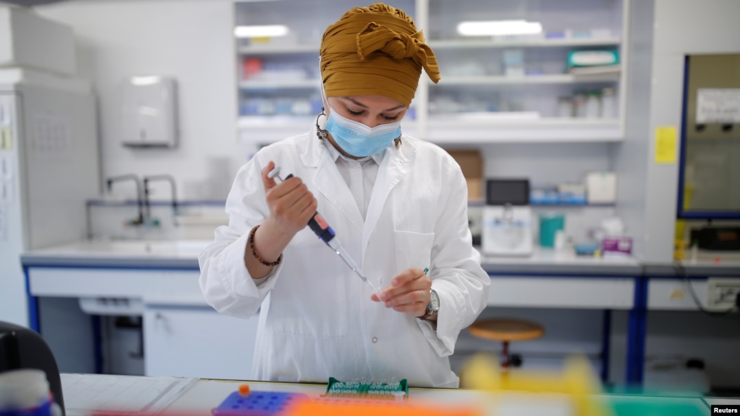 A researcher manipulates proteins in a laboratory as part of a project to develop a COVID-19 nasal spray vaccine at the University of Tours, France, Sept. 15, 2021. 