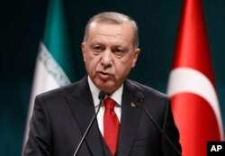 FILE - Turkey's President Recep Tayyip Erdogan talks during a news conference at the Presidential Palace in Ankara, Dec. 20, 2018.