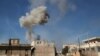 Smoke billows over the town of Saraqib in the eastern part of the Idlib province in northwestern Syria, following bombardment by Syrian government forces, Feb. 27, 2020. 