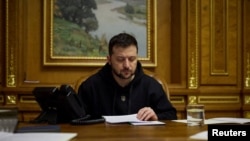 Ukraine's President Zelensky speaks with German Chancellor Scholz via phone line in Kyiv