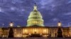 FILE - Lights shine inside the U.S. Capitol Building as night falls in Washington, Jan. 21, 2018.