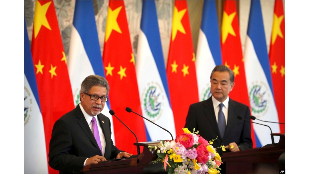 FILE - El Salvador's Foreign Minister Carlos Castaneda speaks as China's Foreign Minister Wang Yi listens at a signing ceremony to mark the establishment of diplomatic relations between El Salvador and China at the Diaoyutai State Guesthouse in Beijing.