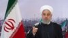 In this photo released by the Iranian president's office, President Hassan Rouhani addresses the nation in a televised speech in Tehran, Feb. 10, 2021.