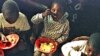 A group of young Rwandans eat at the orphanage run by American Rosamund Carr near Gisenyi, Rwanda, (File July 20, 1997). 