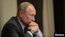 FILE - Russian President Vladimir Putin chairs a meeting at the Novo-Ogaryovo state residence outside Moscow, Russia, Oct. 16, 2019.
