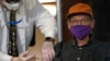 A man is vaccinated against COVID-19 at a nursing home in New York, Dec. 21, 2020.