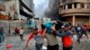 A wounded protester is carried to receive first aid during clashes with security forces on Rasheed Street in Baghdad, Iraq, Nov. 28, 2019. 