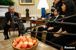 FILE - Then-President Barack Obama meets with youths who received Deferred Action for Childhood Arrivals (DACA) status at the White House in Washington, Feb. 4, 2015.