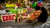 Jean Dasilva sits next to a makeshift memorial for the victims of Sunday's mass shooting at the Pulse Orlando nightclub as he mourns the loss of his friend Javier Jorge-Reyes Tuesday, June 14, 2016.