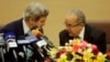 U.S. Secretary of State John Kerry talks with Algeria's Foreign Minister Ramtane Lamamra (R) before addressing a news conference at the Foreign Ministry in Algiers, April 3, 2014. 