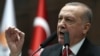 FILE - President of Turkey and leader of Justice and Development (AK) Party Recep Tayyip Erdogan speaks at the party's group meeting at Grand National Assembly of Turkey in Ankara, Feb. 12, 2020.